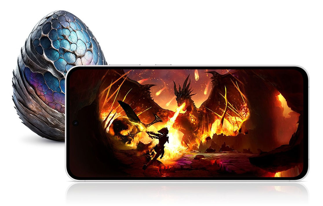 A Galaxy S24 FE device seen from the front and horizontal, displaying a vivid image of a warrior battling a dragon in a fiery setting. Behind the device, there is a dragon-like egg with blue and purple scales.